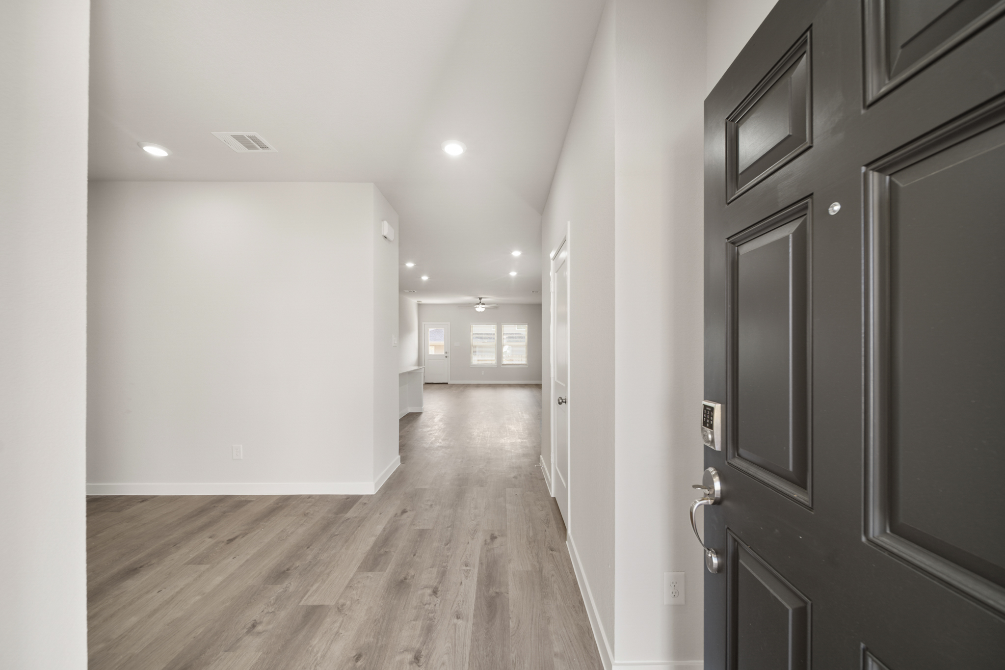 A hallway with white walls.