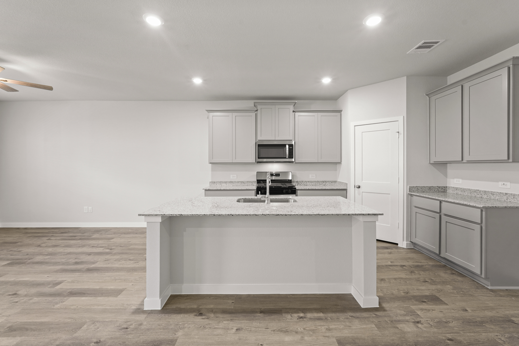 A kitchen with white cabinets.