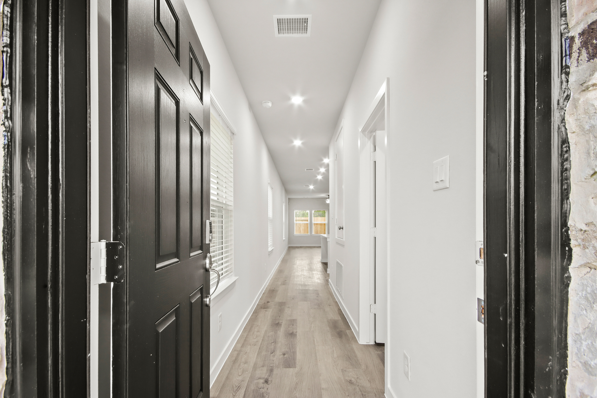 A hallway with black doors.
