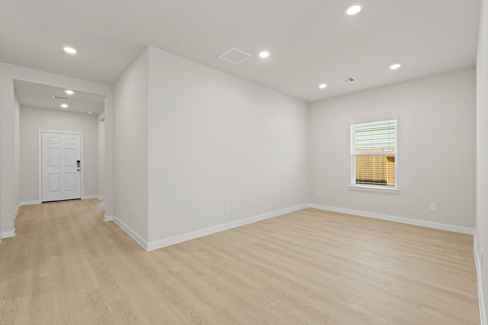 A room with a wood floor and white walls.