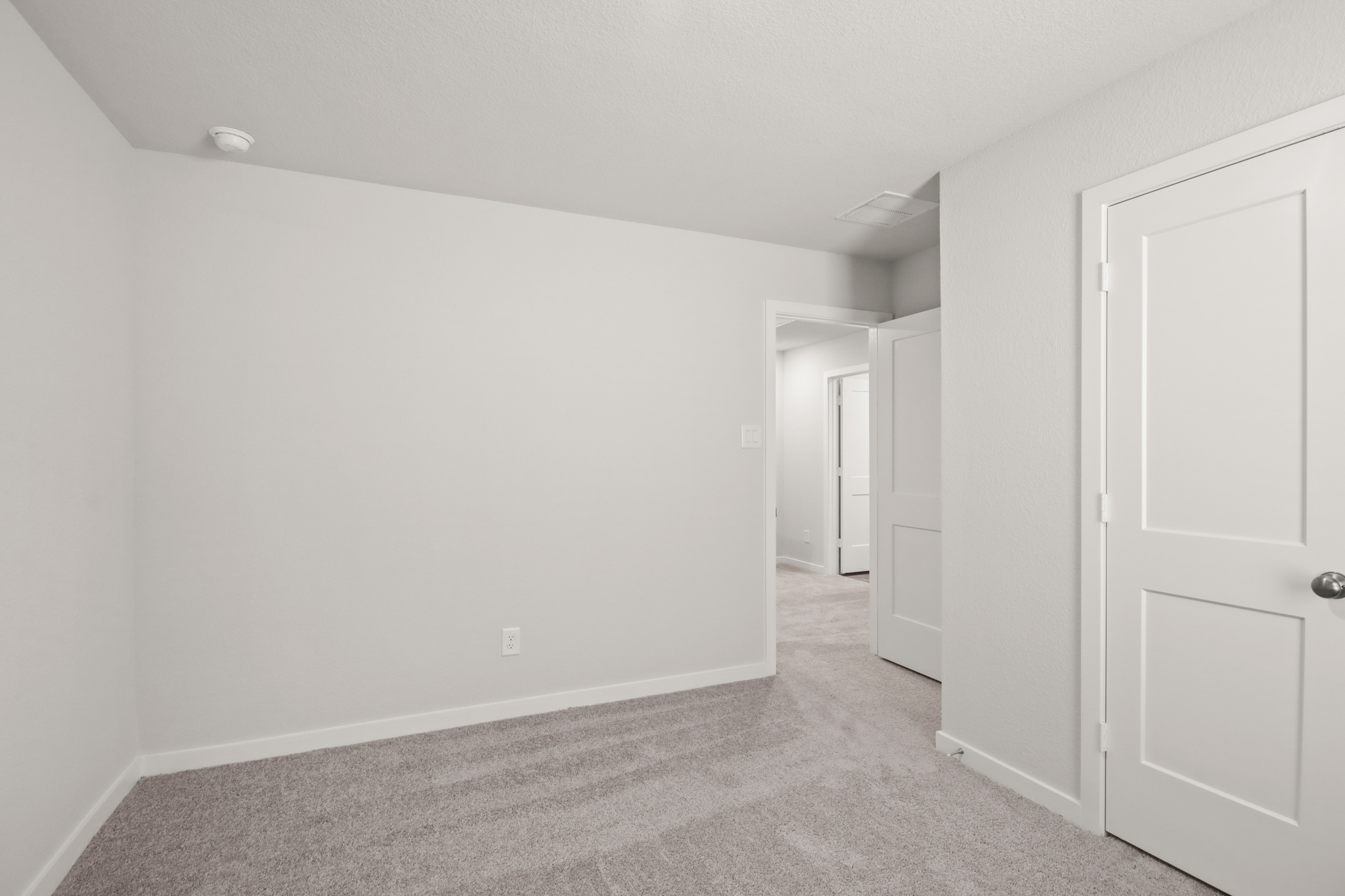 A hallway with white doors.