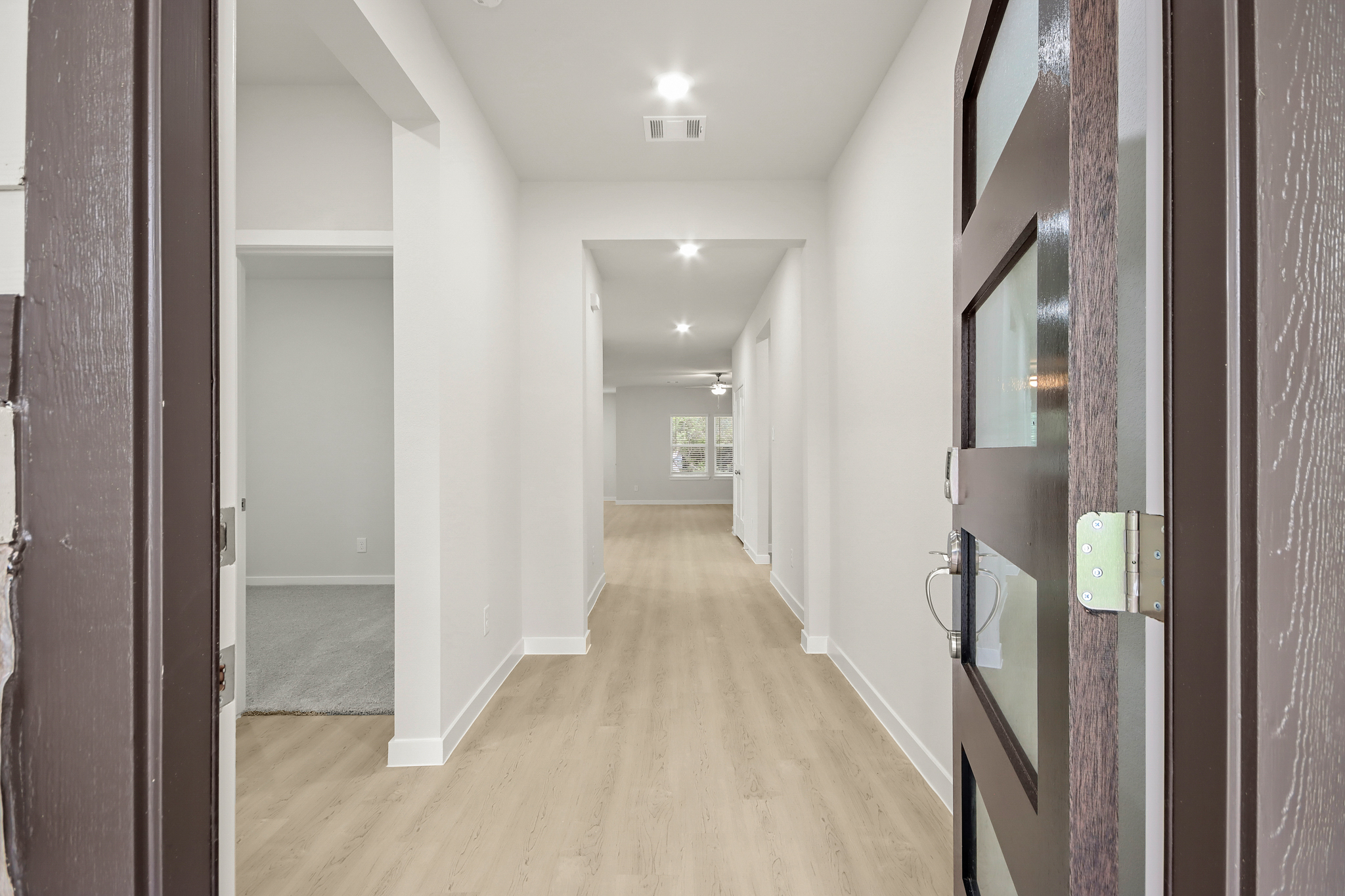 A hallway with white walls.