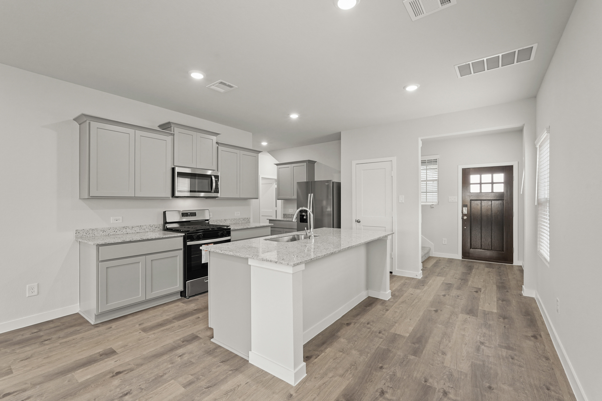 A kitchen with white cabinets.