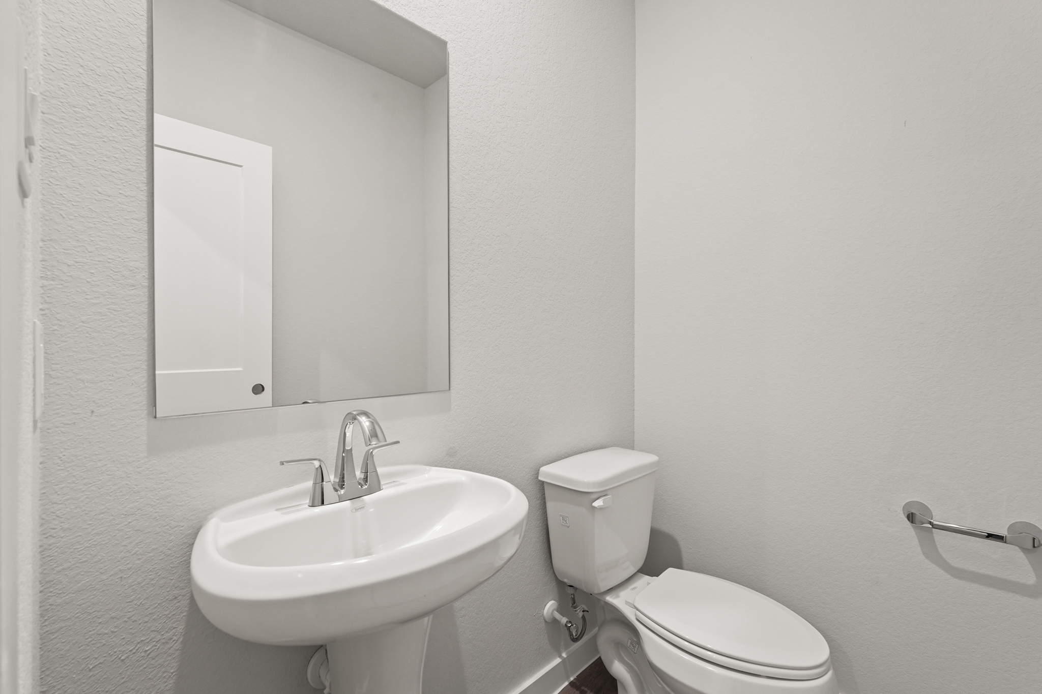 A bathroom with a sink and toilet.