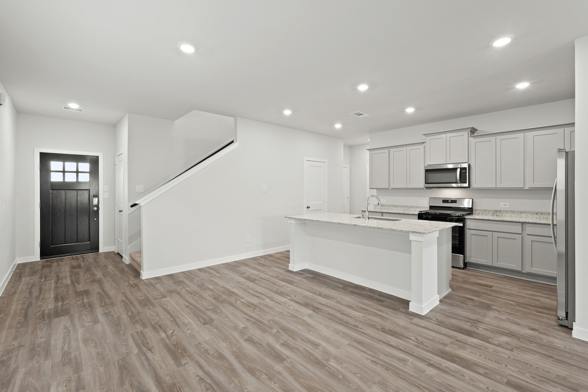 A kitchen with white cabinets.