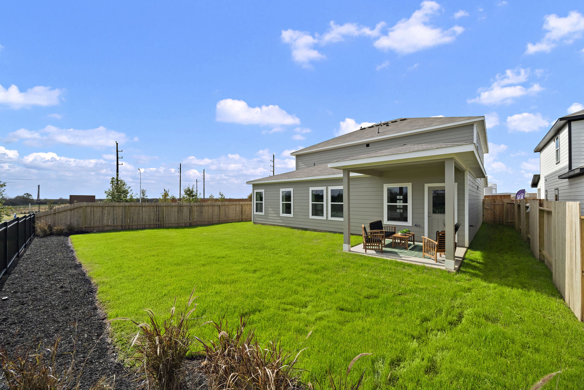 A house with a fence and grass.