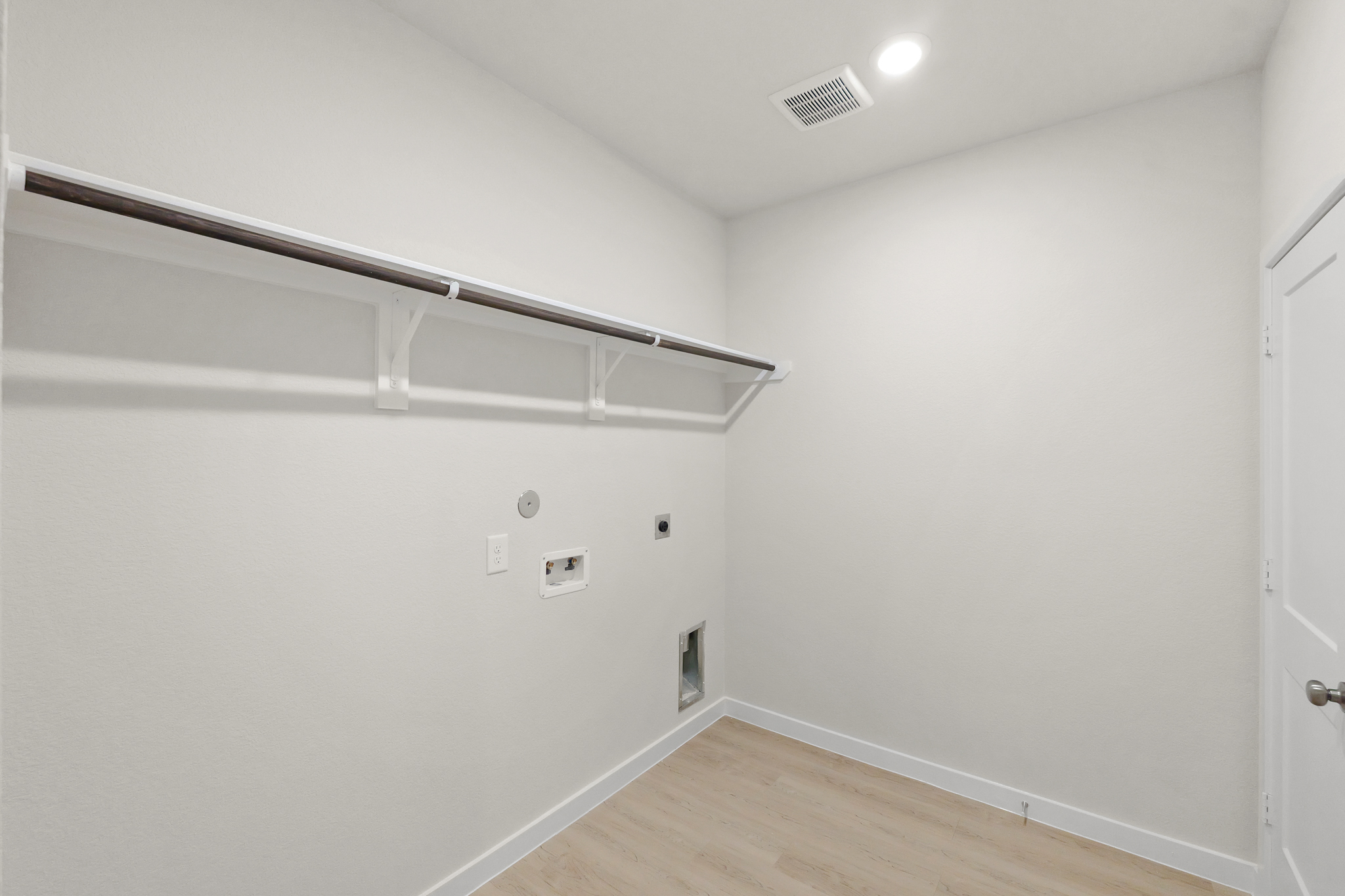 A white room with a wood floor.