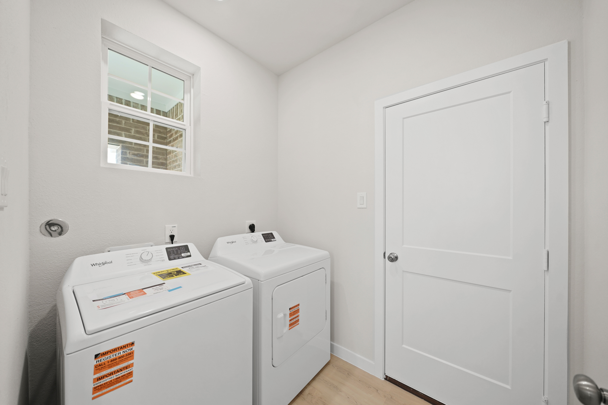 A laundry room with a white door.