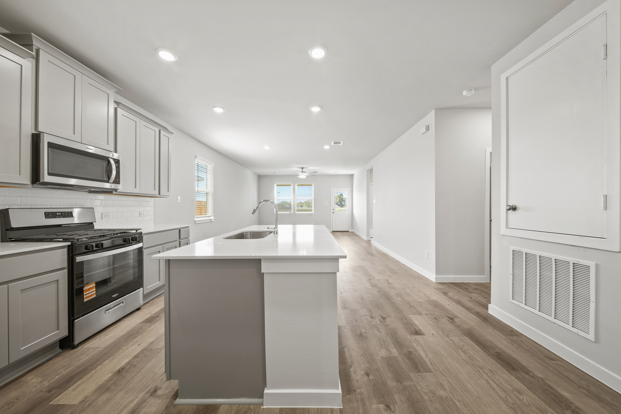 A kitchen with white cabinets.