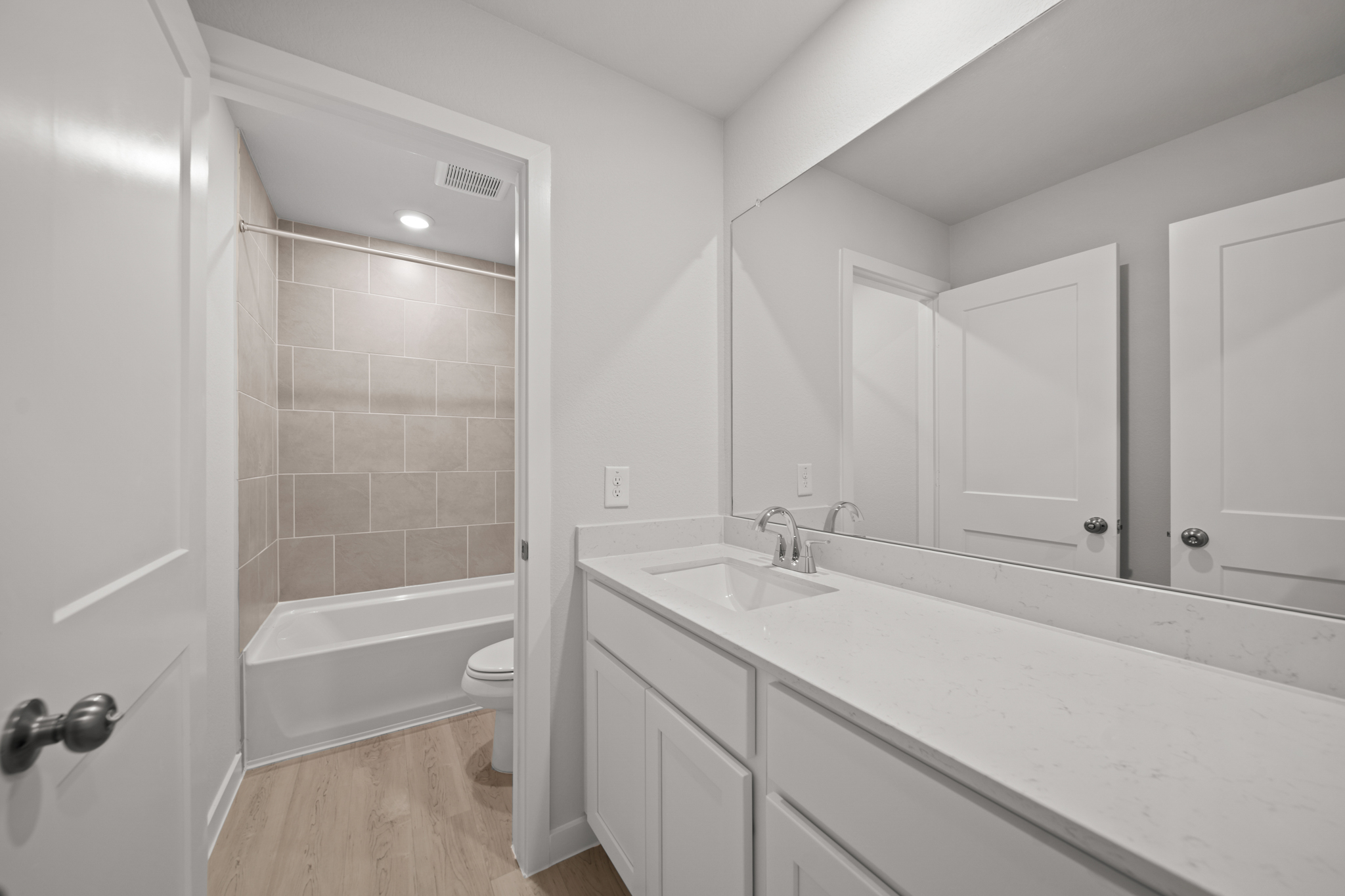 A bathroom with a tub sink and toilet.