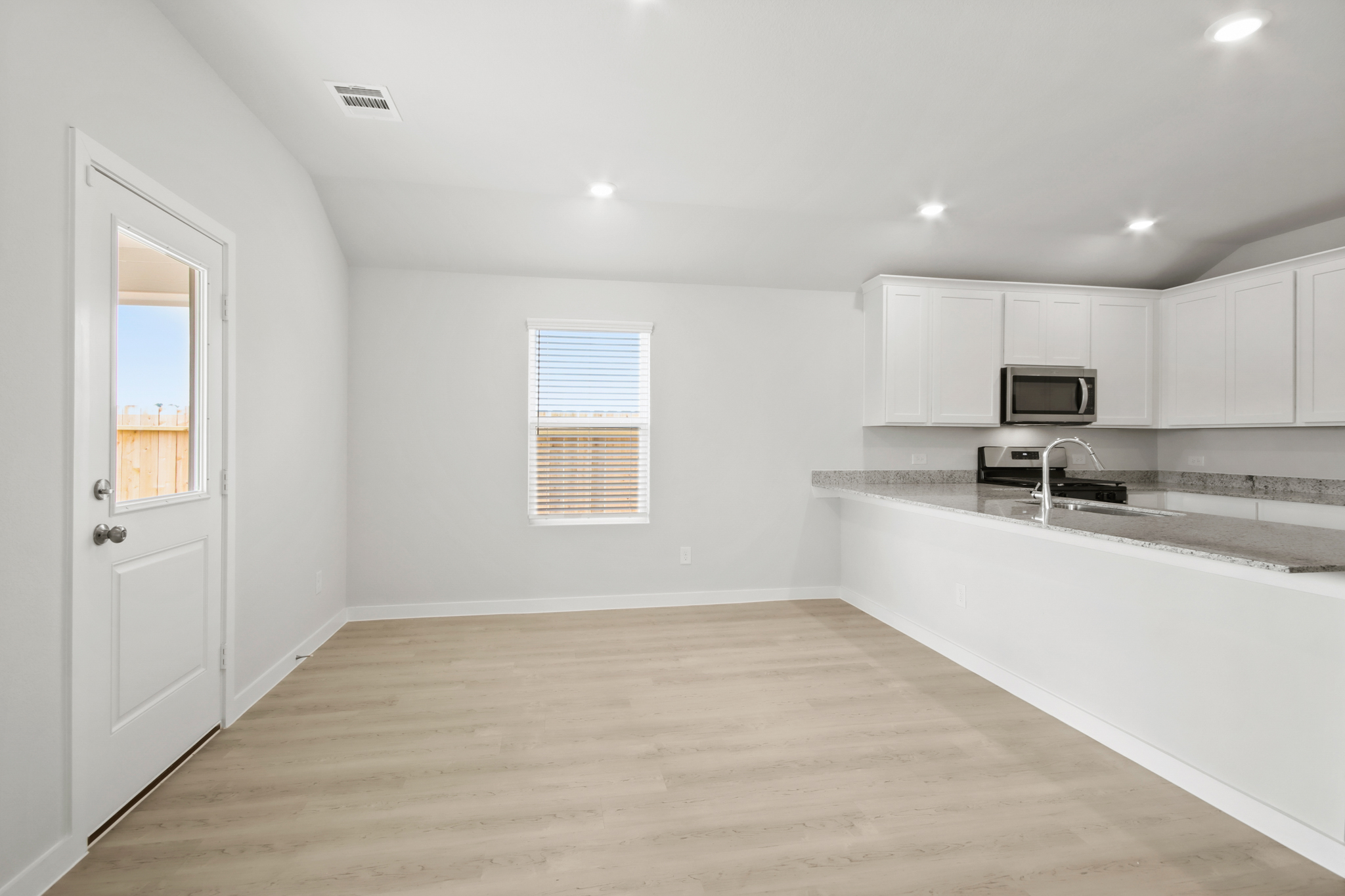 A kitchen with white cabinets.
