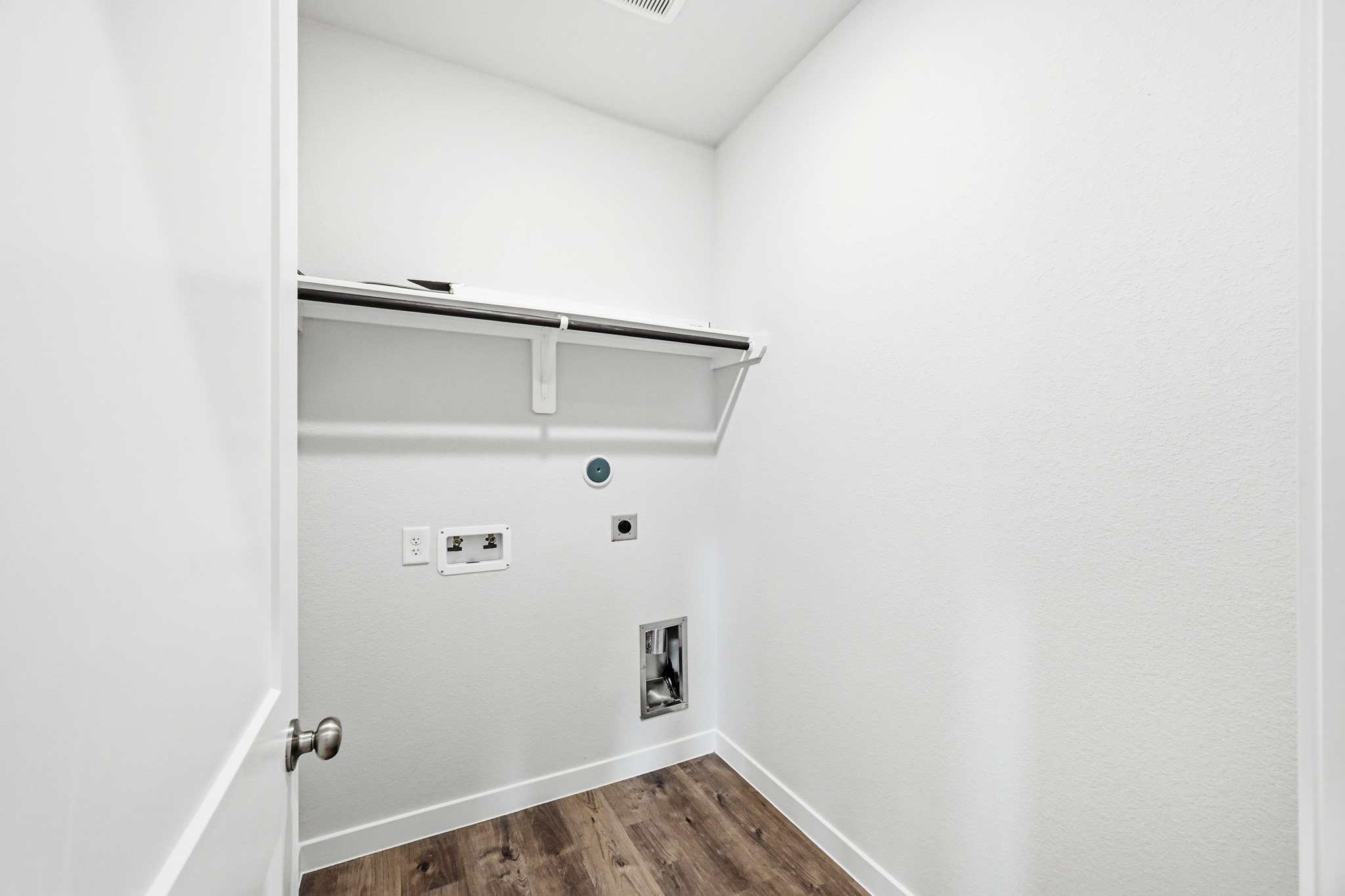 A white wall with a door and a white door.