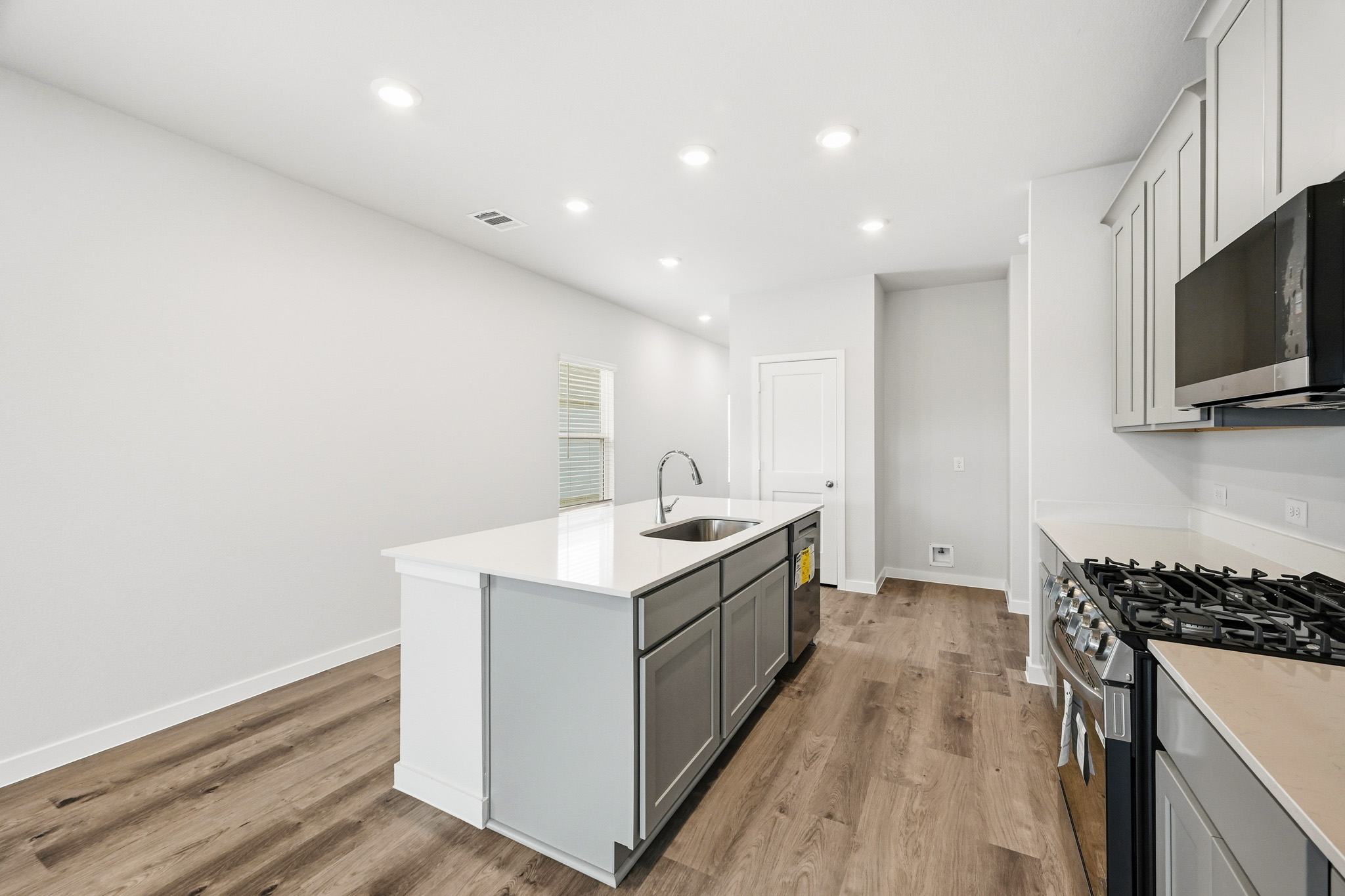 A kitchen with white cabinets.