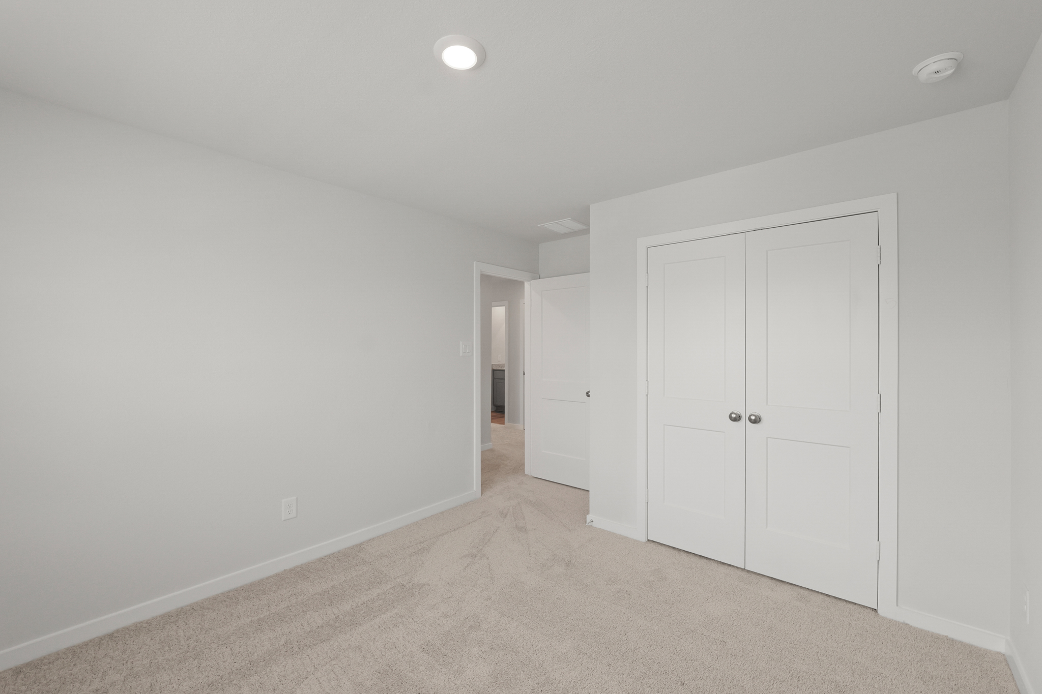 A hallway with white doors.