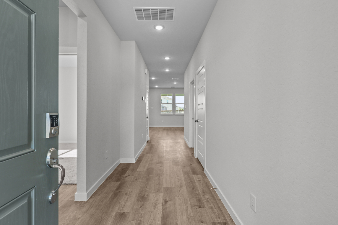 A hallway with white walls.