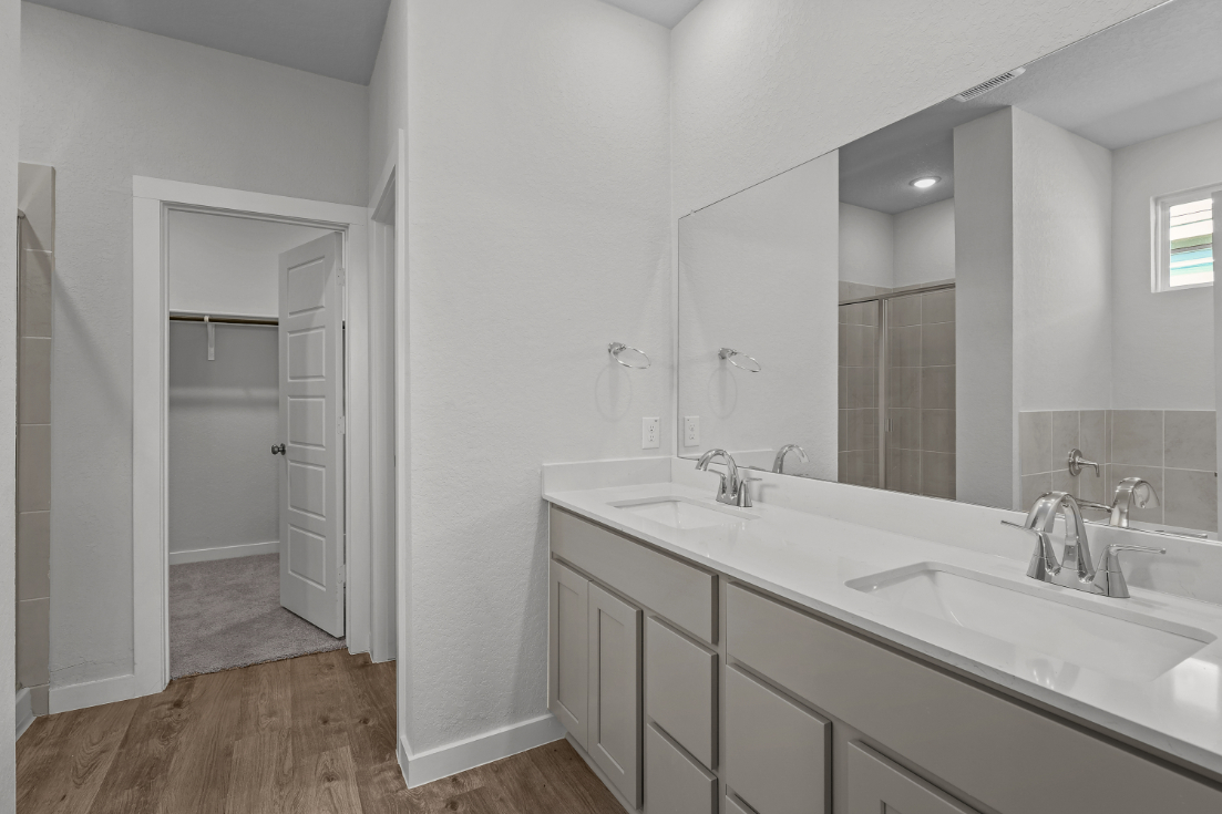A bathroom with a large mirror.