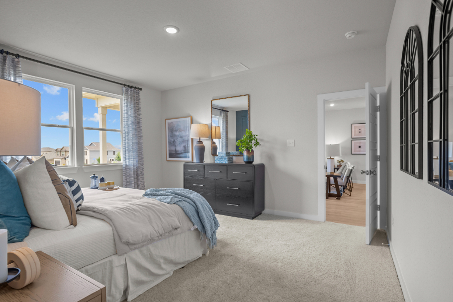 A bedroom with a bed and a desk.