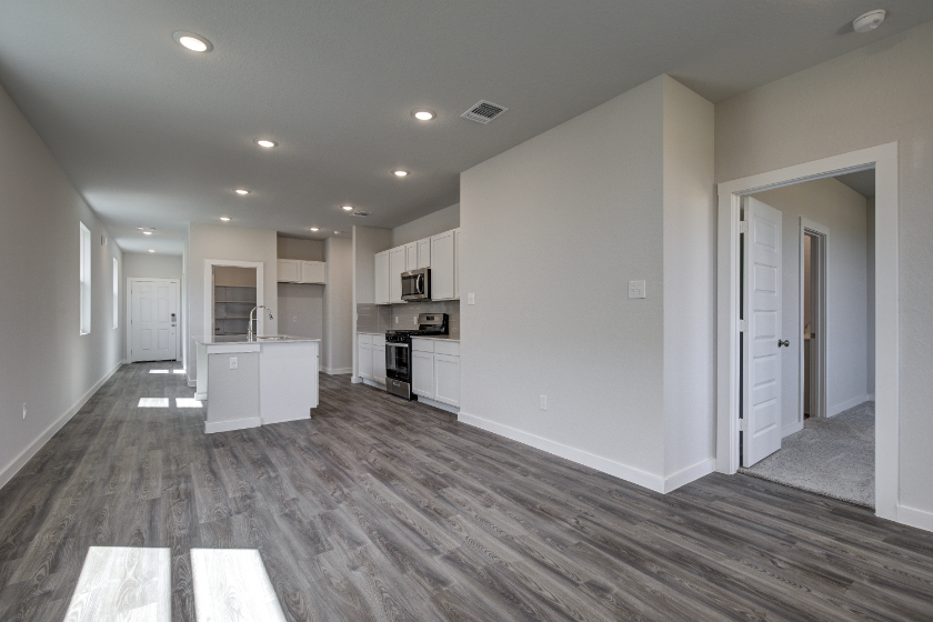 A kitchen with white cabinets.