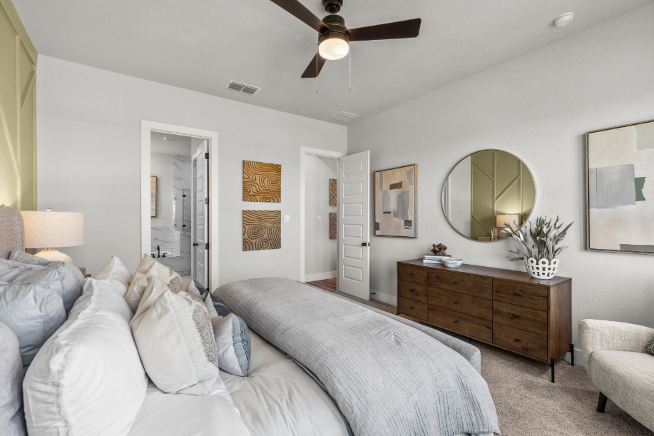 A bedroom with a bed and a fan.