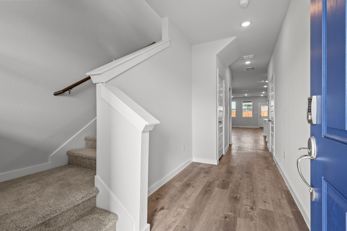A hallway with white walls.