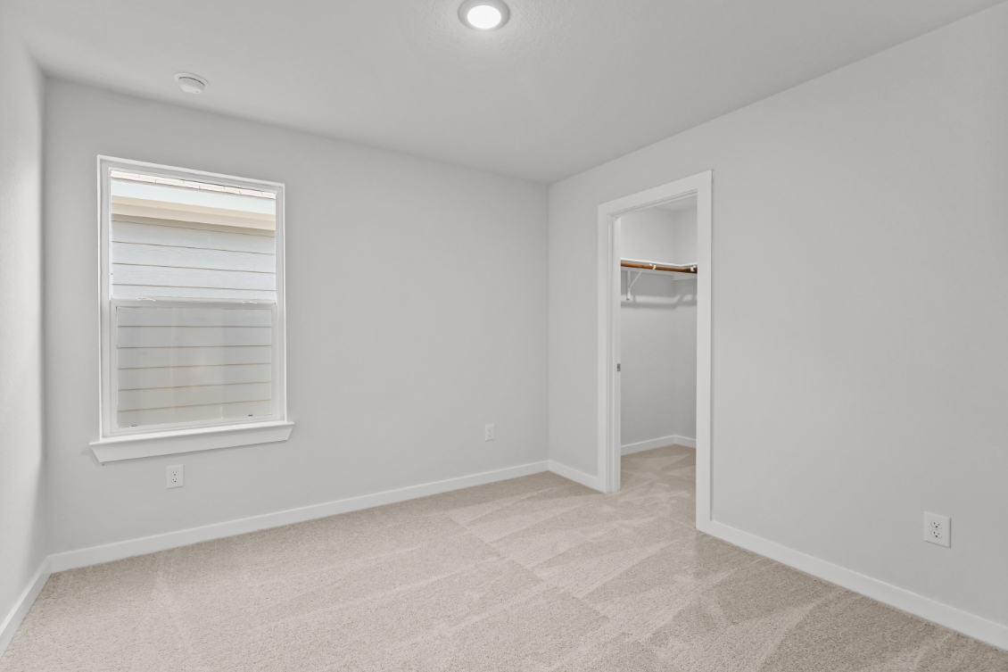 A room with a window and a door.