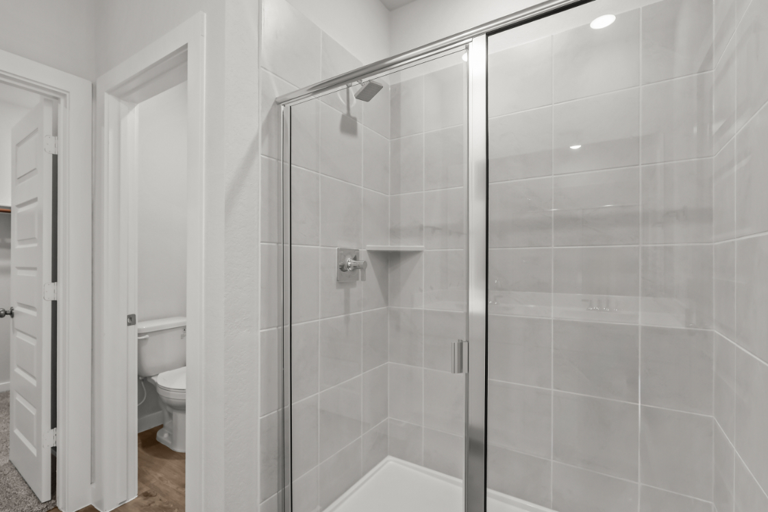 A shower with a glass door.