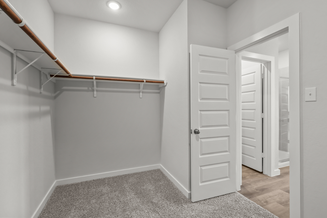 A white hallway with white doors.