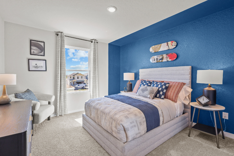 A bedroom with a bed and a desk.