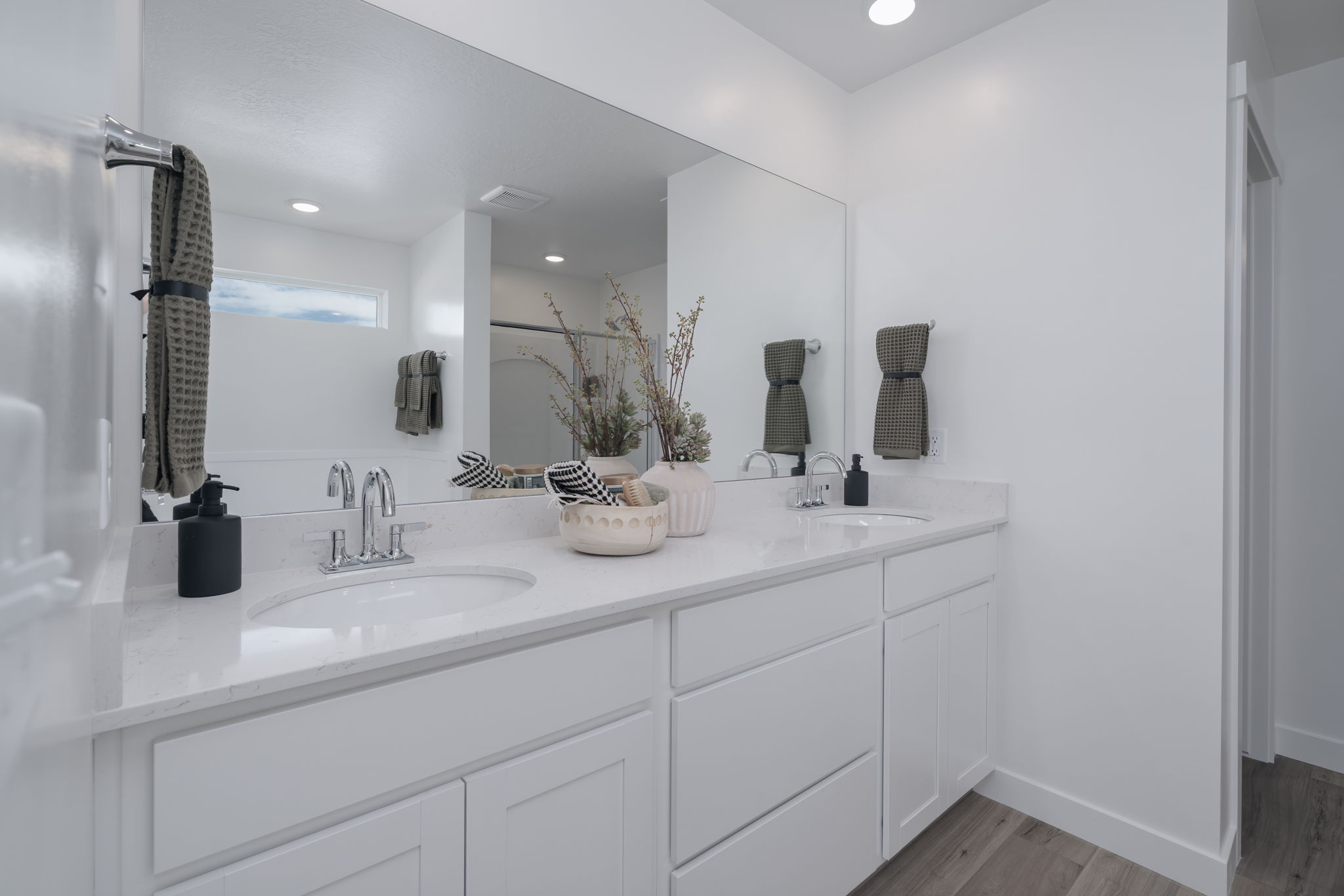 A bathroom with a large mirror.