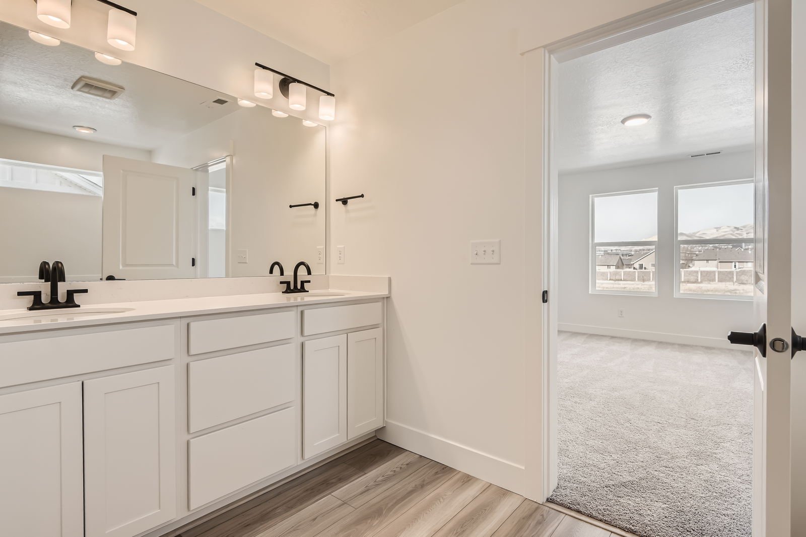 A bathroom with white cabinets.
