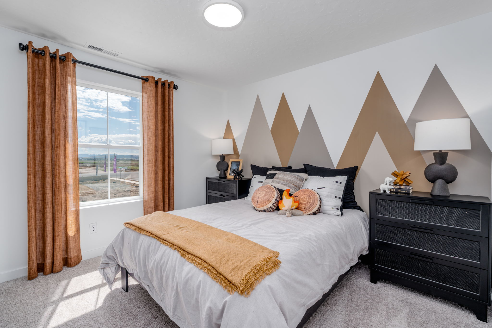 A bedroom with a large window.