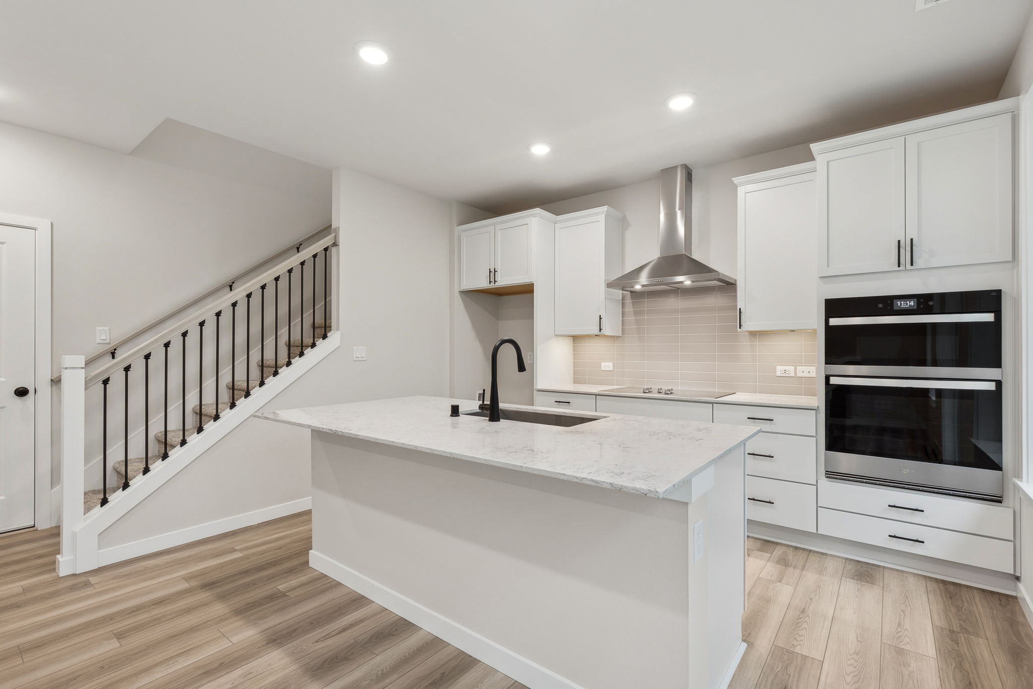 A kitchen with white cabinets.