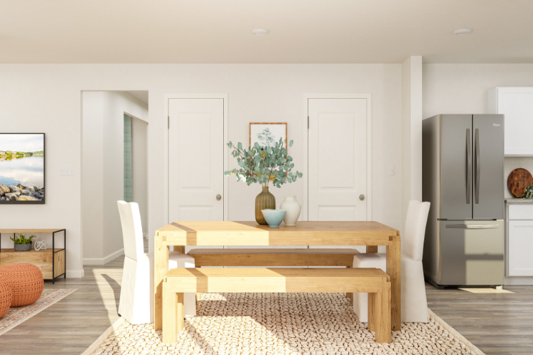 A living room with a table and chairs.