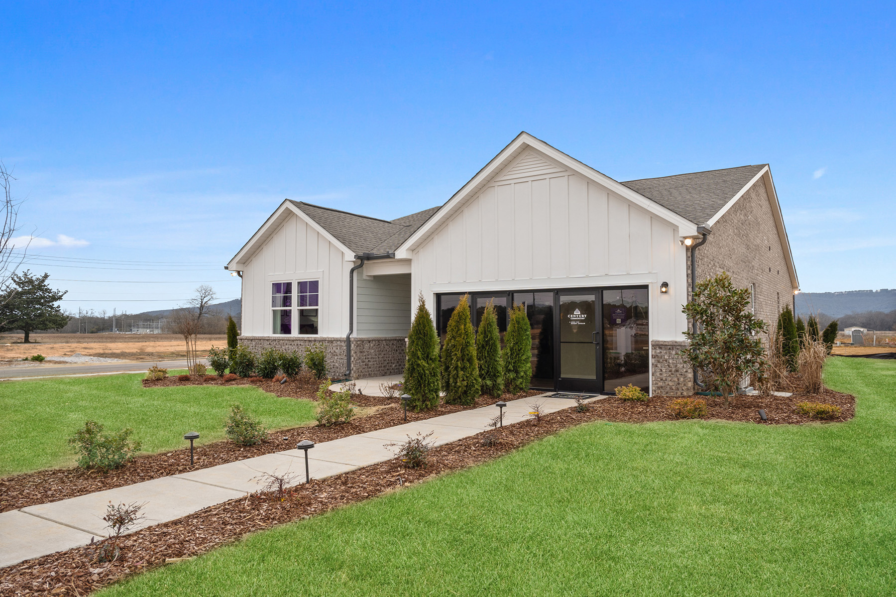 A house with a large yard with Southfork Ranch in the background.