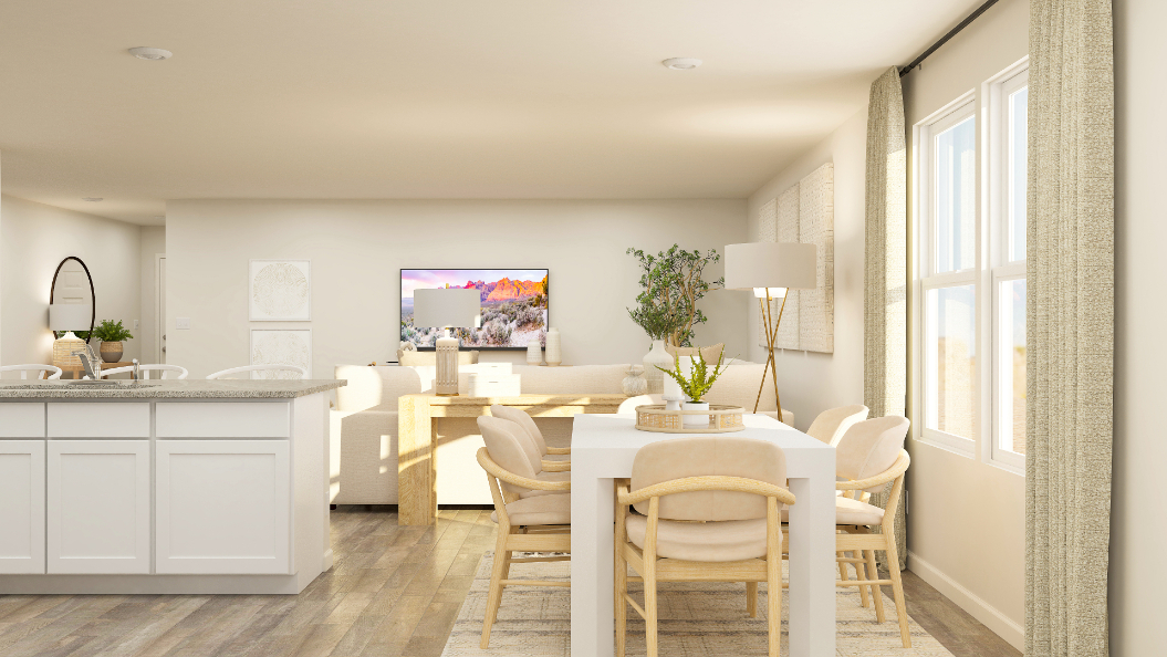 A kitchen with a table and chairs.