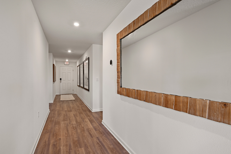 A hallway with white walls.