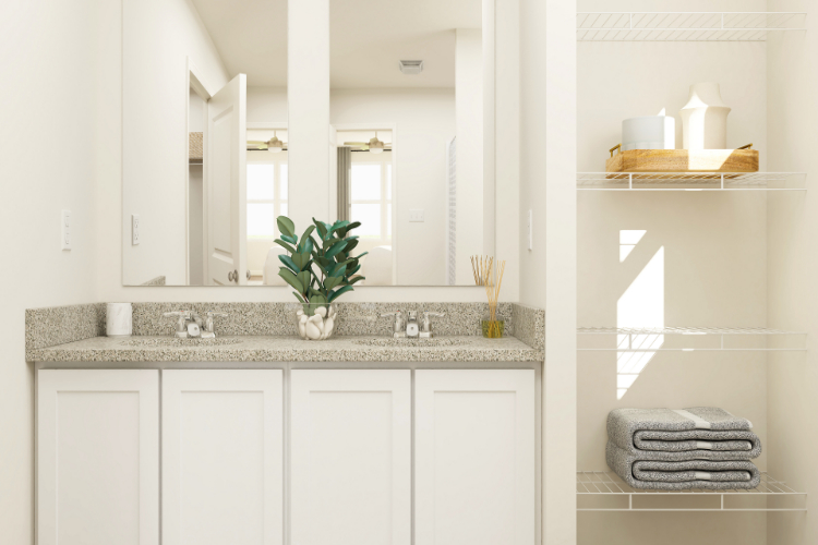 A bathroom with white cabinets.