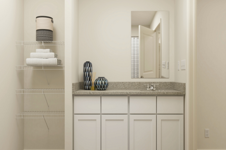 A bathroom with a mirror and a shelf.