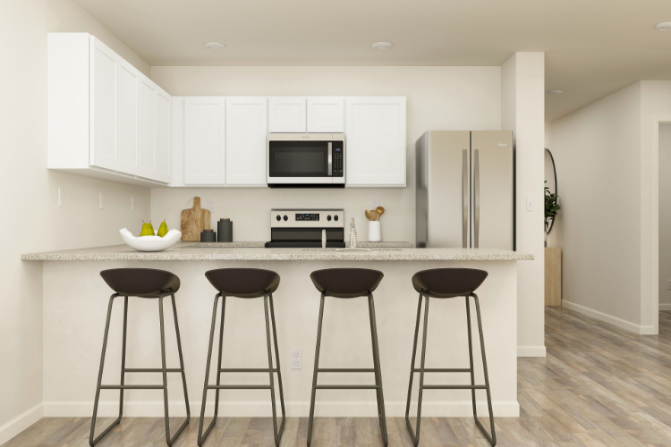 A kitchen with stools and a refrigerator.