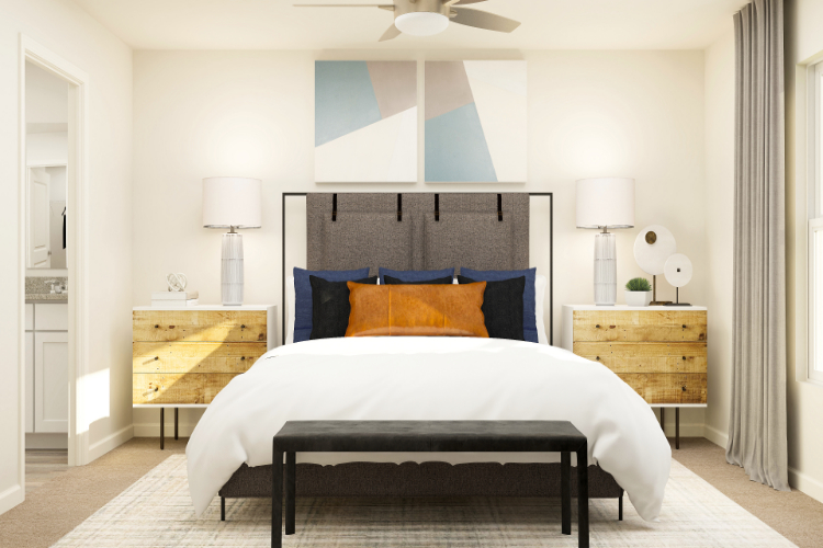 A bedroom with a bed and lamps.