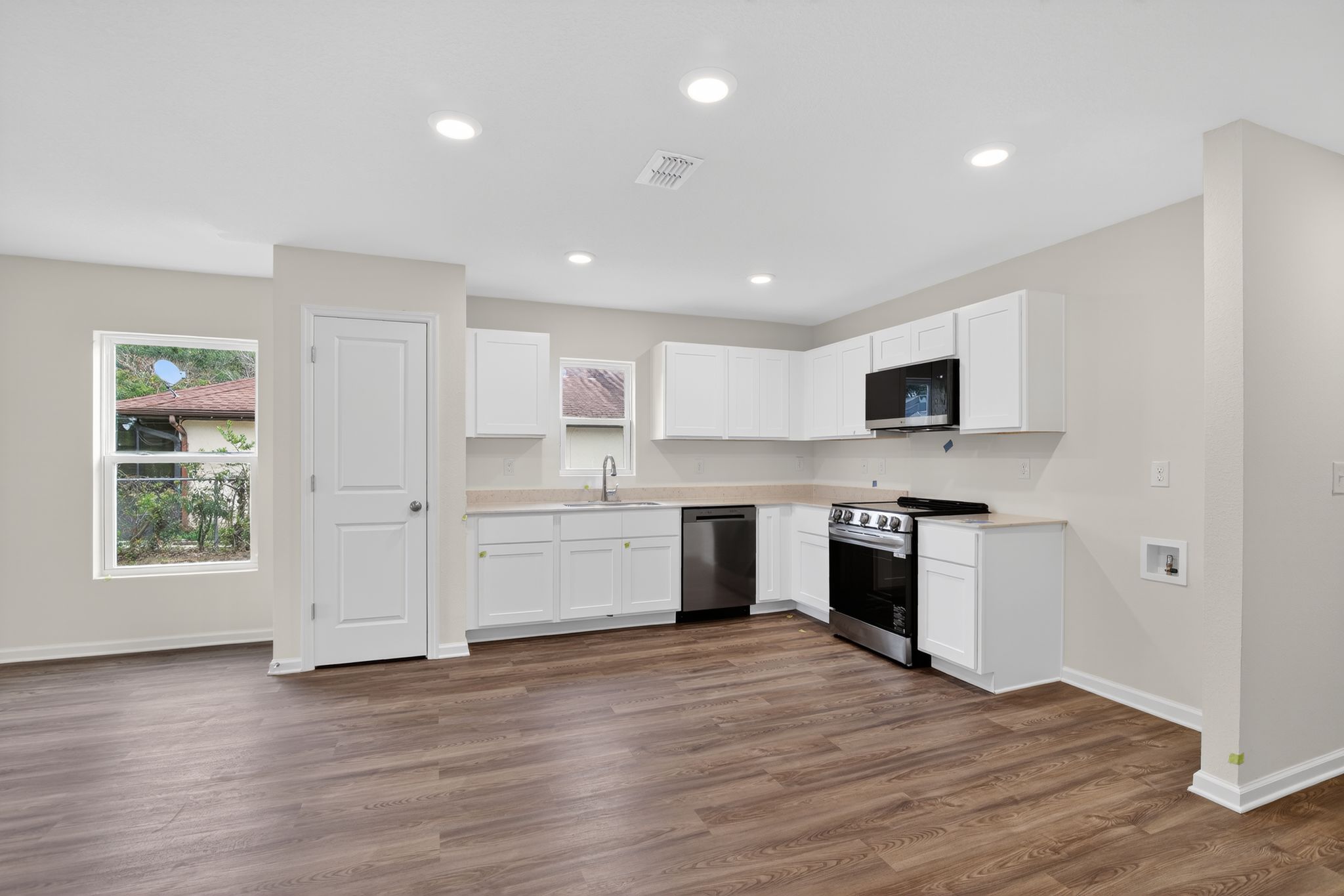A kitchen with white cabinets.