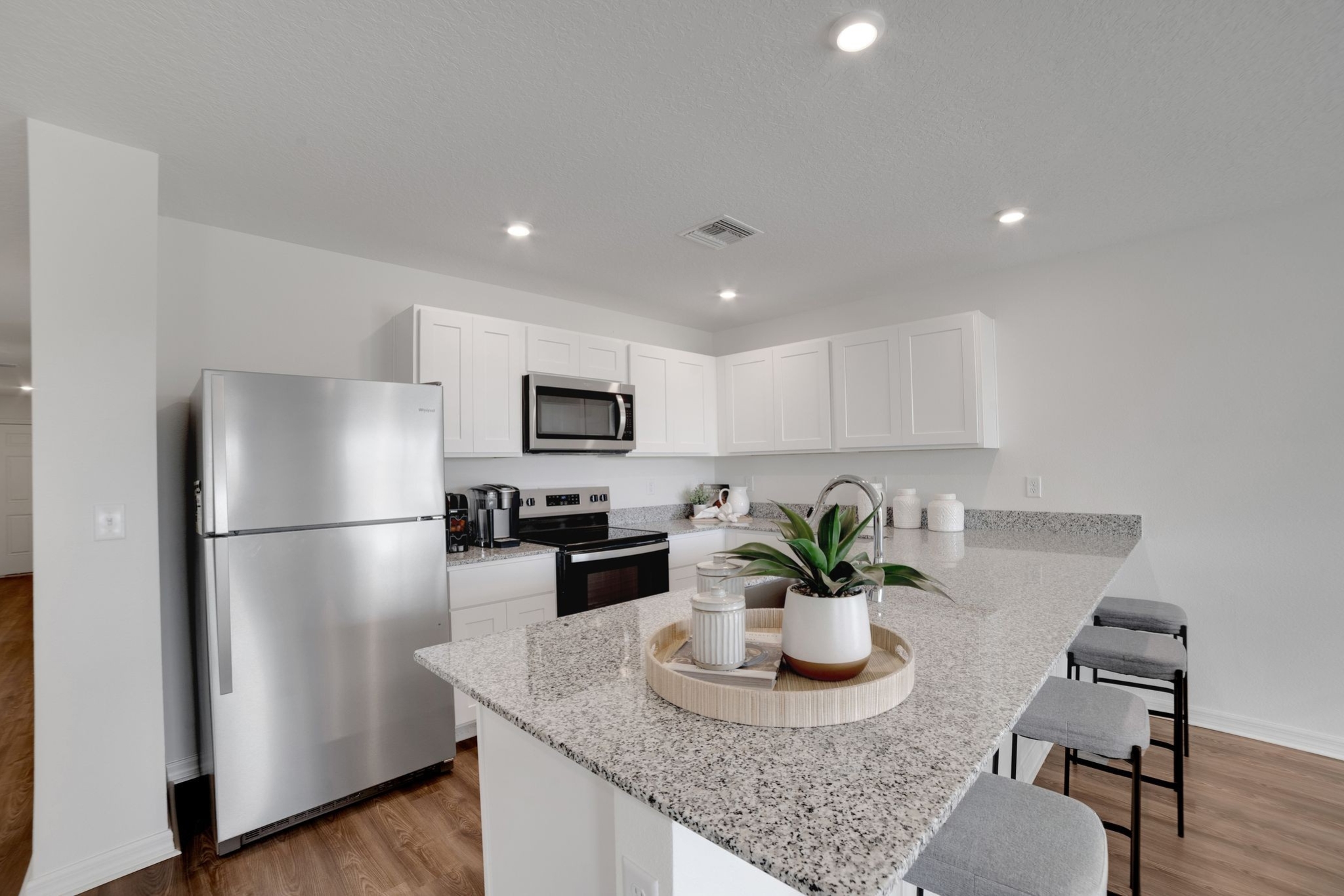 A kitchen with white cabinets.