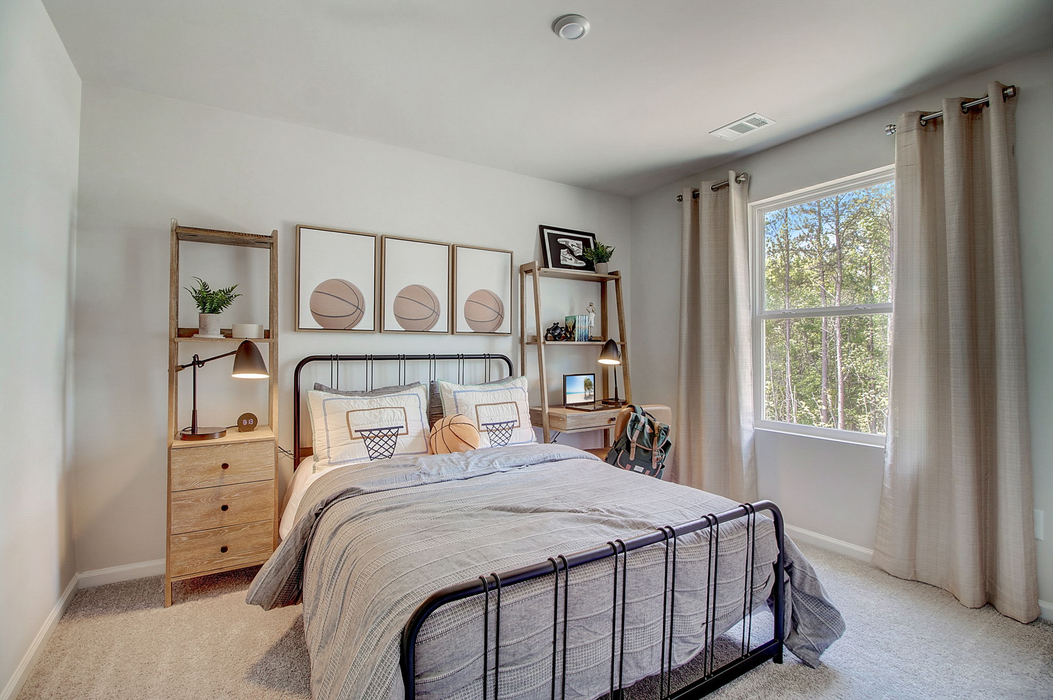 A bedroom with a bed and a shelf with books on it.
