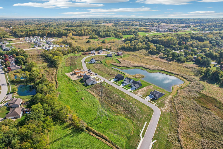 A landscape with a river and houses.