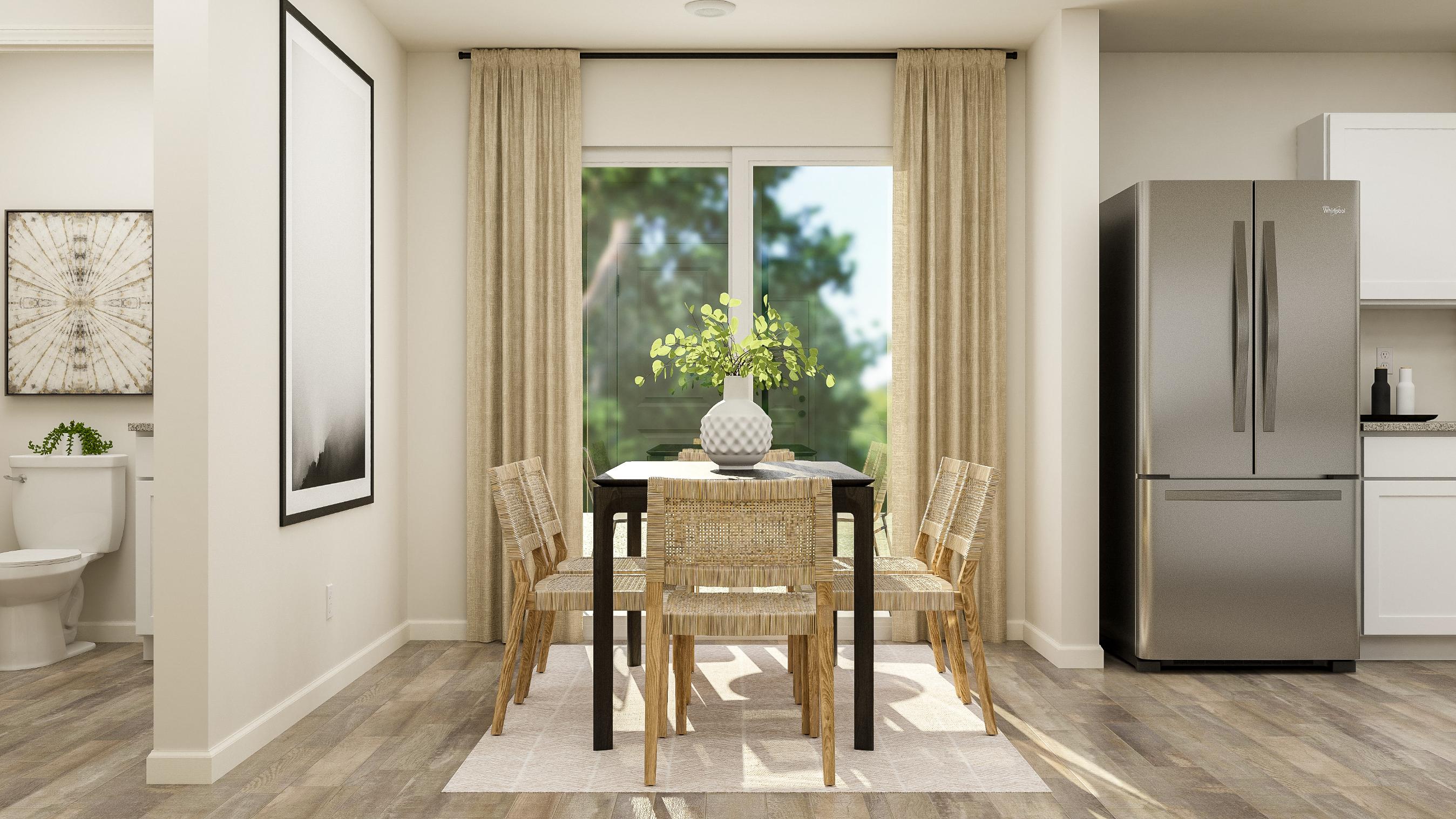 A kitchen with a dining table and chairs.