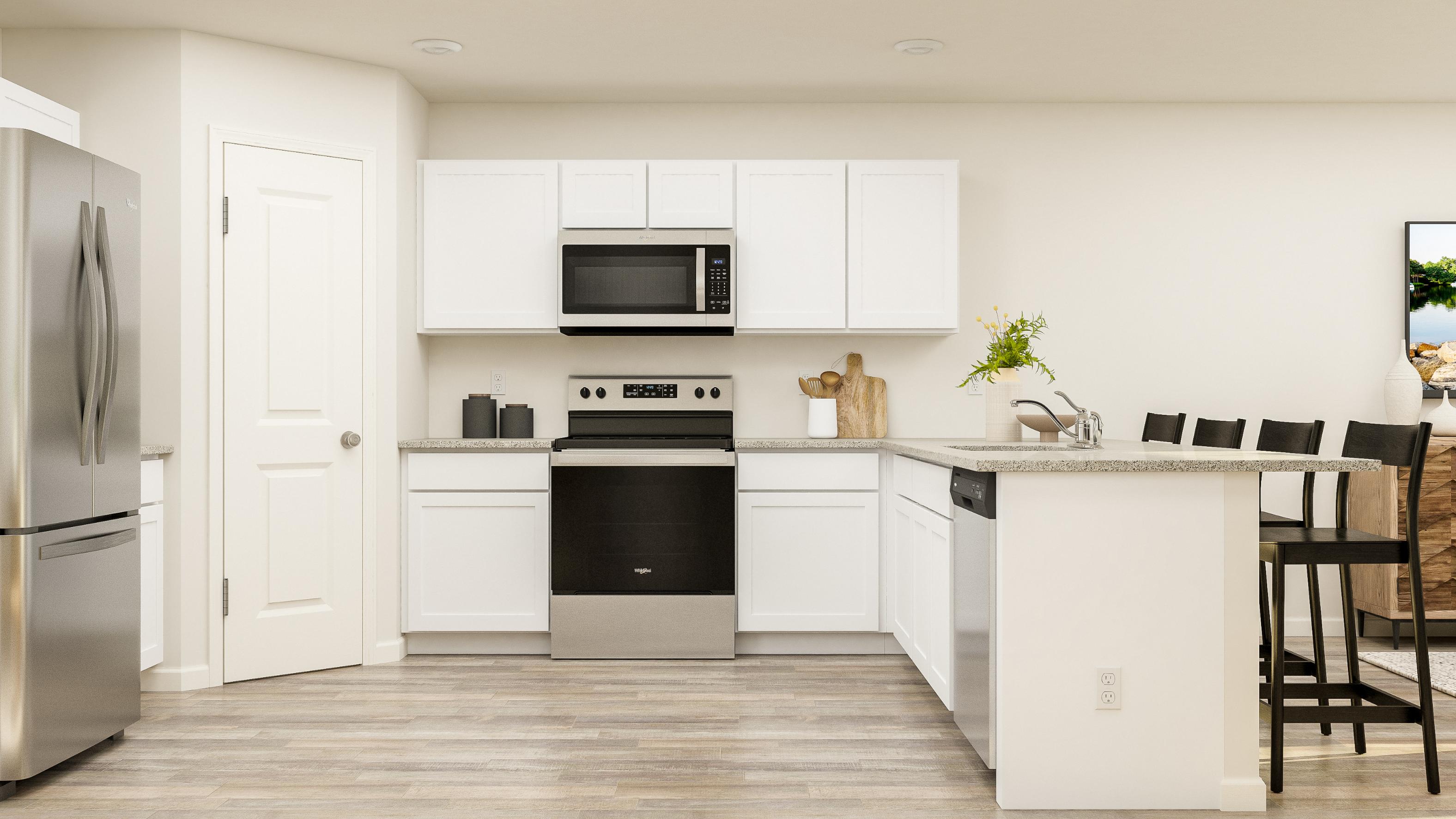 A kitchen with white cabinets.
