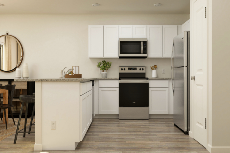 A kitchen with white cabinets.