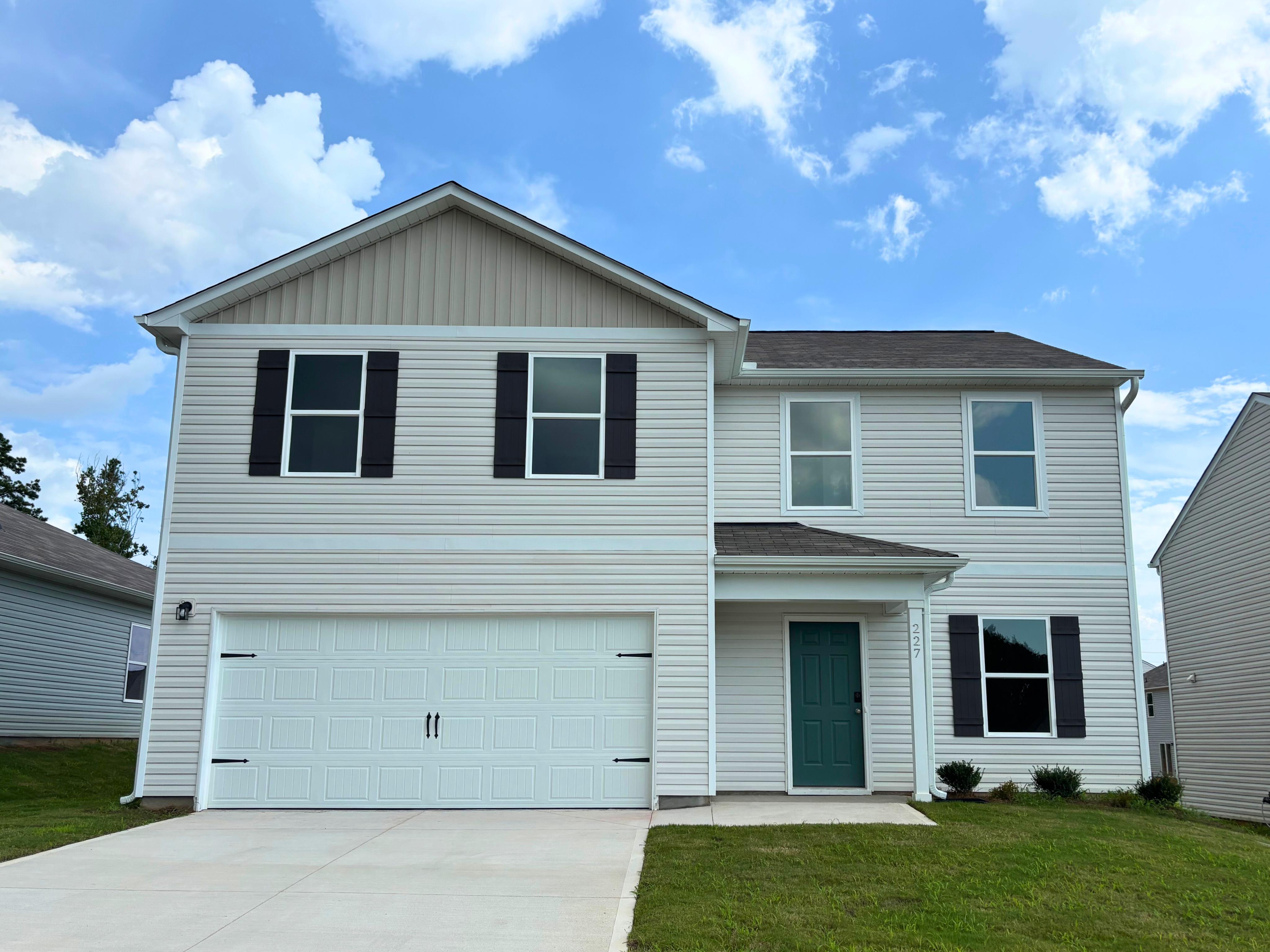 A white house with a garage.