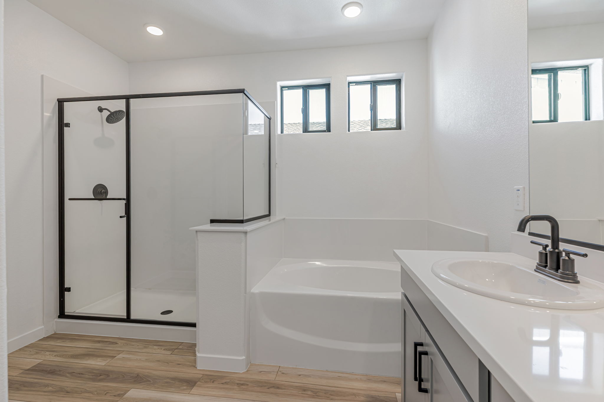 A bathroom with a tub sink and shower.