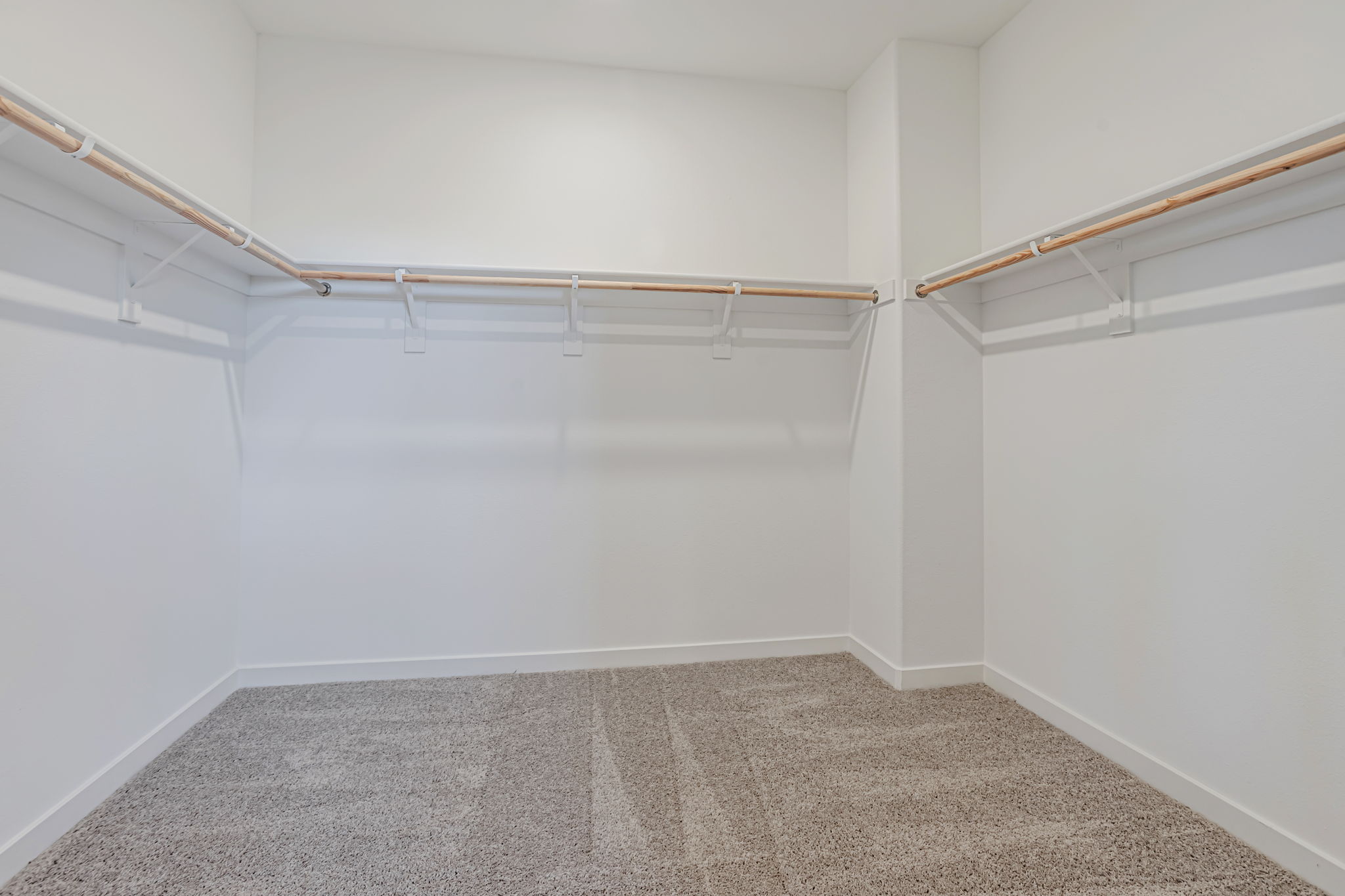 A white room with a carpet.